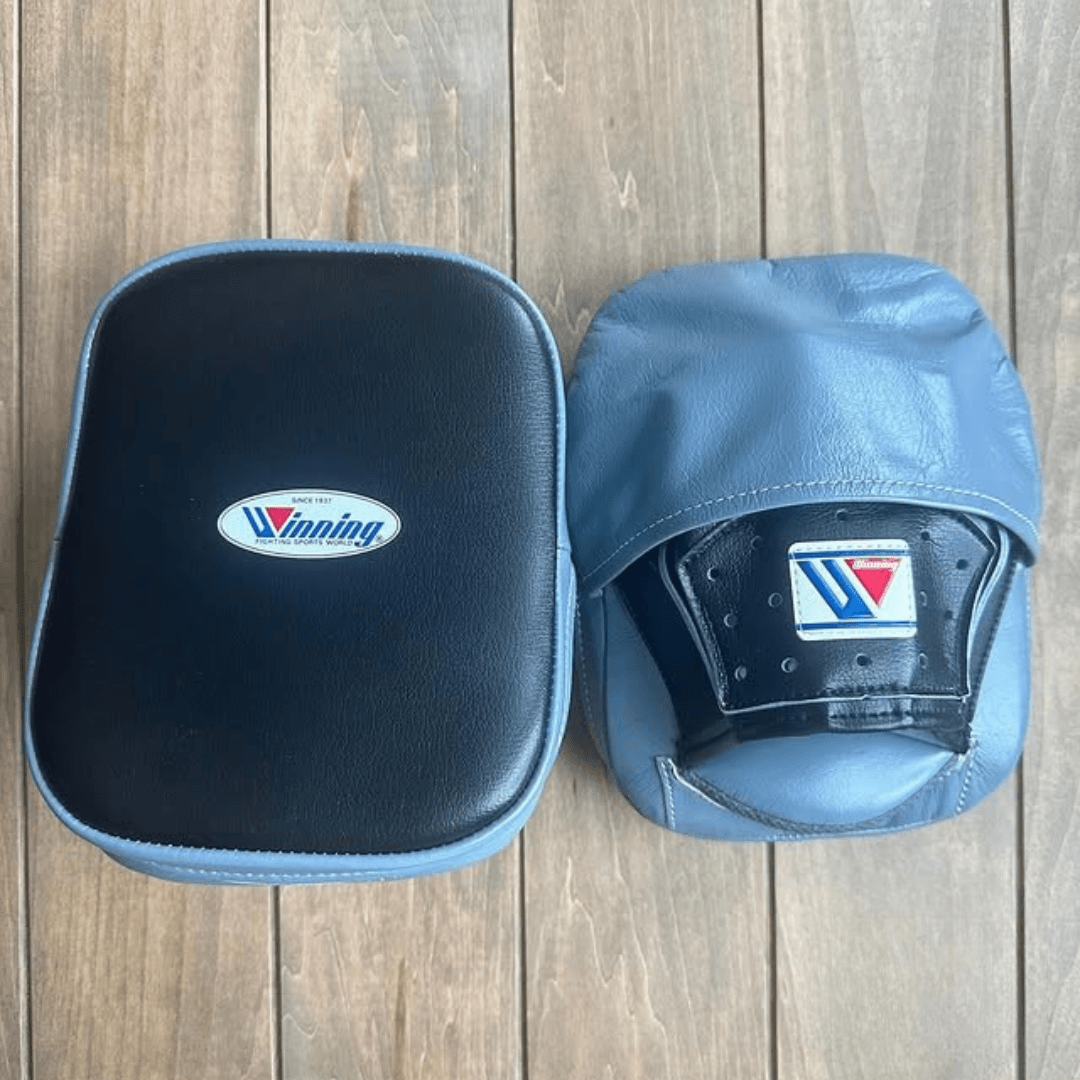 Here are a few strong title options for your product, depending on the focus and style you prefer for your store:  Recommended Product Titles Winning Style Leather Focus Mitts – Handcrafted Coach Punch Pads